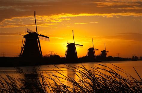 Sunrise Windmills - The Kinderdijk Windmill Park in Holland features a large… | Windmill ...