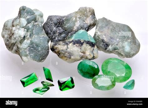 Emerald - rough mineral and cut gemstones Stock Photo - Alamy