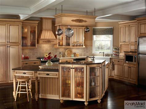 This traditional kitchen with KraftMaid cabinetry and a multi-tiered island provides a balance ...