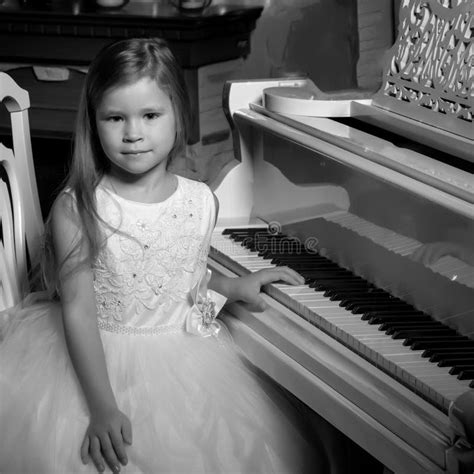 Little Girl Plays the Piano by Candlelight. Stock Image - Image of ...