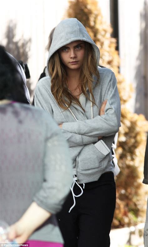 Make-up free Cara Delevingne hangs around Suicide Squad set in a hoodie before transforming into ...