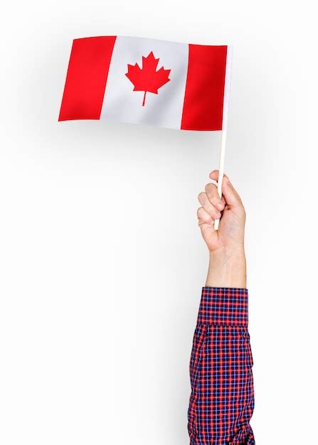 Person waving the flag of canada Photo | Free Download