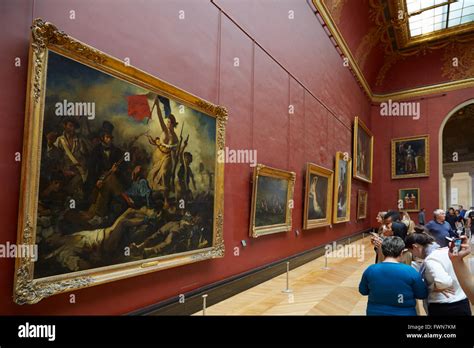 Liberty Leading the People by Eugene Delacroix in the Louvre museum in Paris with visitors Stock ...