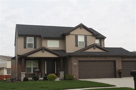 Stunning Brown House with Stone Siding and Black Trim