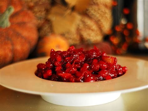 a white plate topped with cranberry sauce on top of a table next to ...