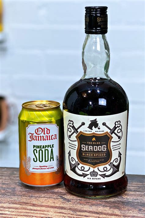 a bottle of soda and a can of soda sit on a table next to each other