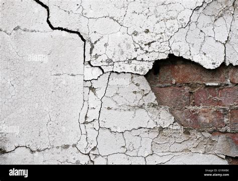 Old cracked wall background showing bricks underneath Stock Photo - Alamy