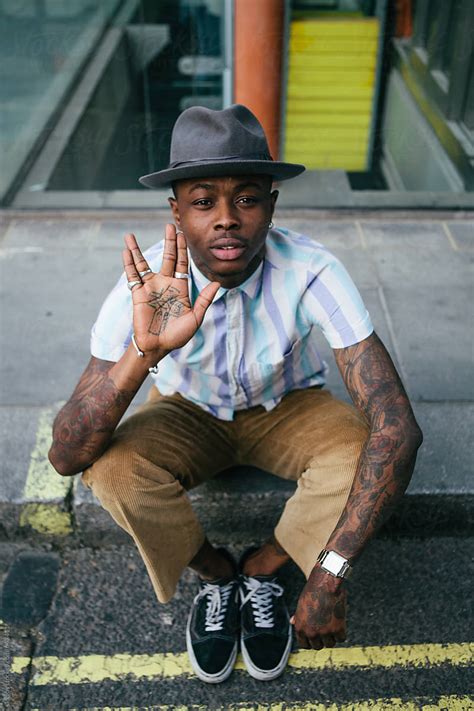 "Stylish Young Black Man With Tattoos In An Urban Setting" by Stocksy Contributor "Kkgas" - Stocksy