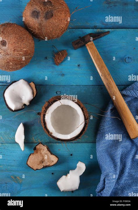 Opening coconut with hammer Stock Photo - Alamy