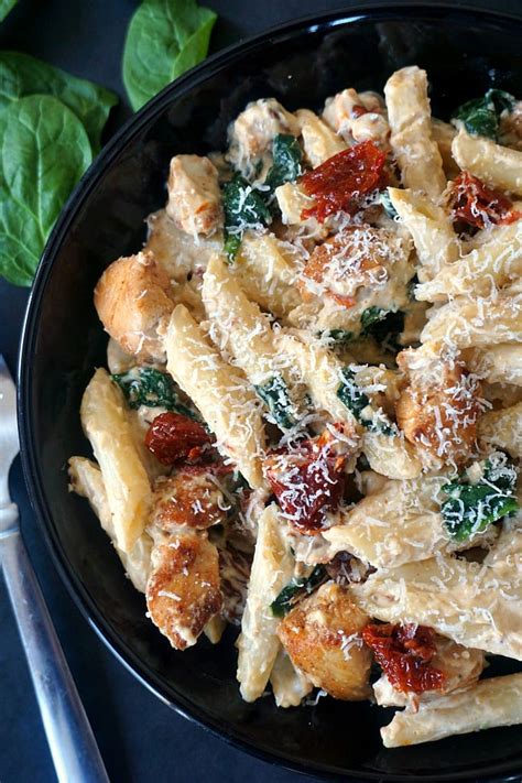 Chicken alfredo penne pasta with sun-dried tomatoes and spinach