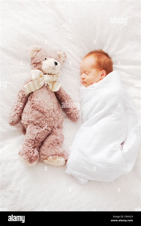 Swaddled sleeping baby Stock Photo - Alamy