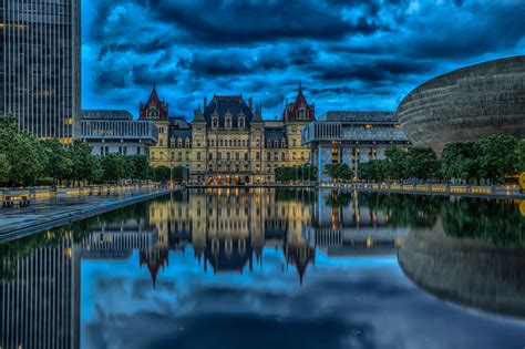 The New York State Capitol is reflected in the pond, Albany. USA ...