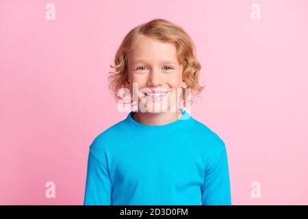 Photo of cheerful sweet schoolkid toothy smile arms under cheek isolated on yellow color ...