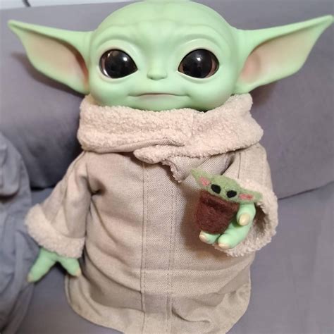 My Baby Yoda holding his own Baby Yoda : r/BabyYoda