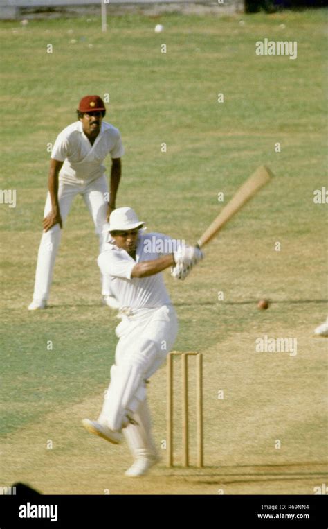 Indian cricket player Sunil Gavaskar batting and Kapil Dev fielding ...