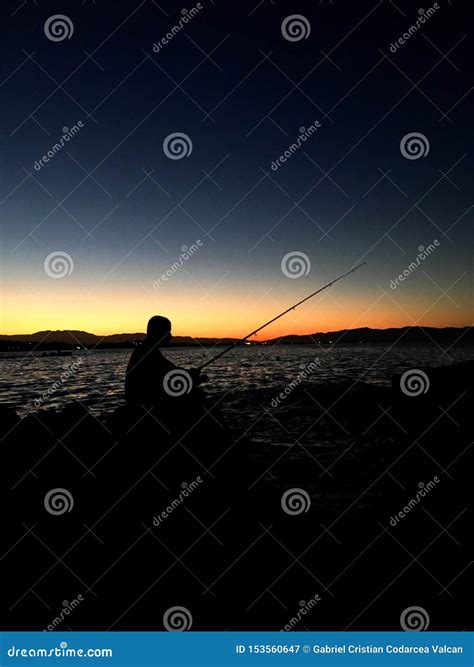 Silhouette of Man Fishing with Fishing Rod during Sunset Stock Image ...