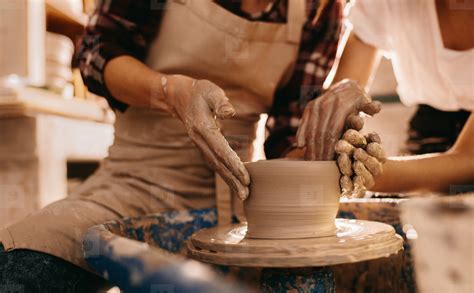 Two women at a pottery workshop making clay pots stock photo (133735 ...