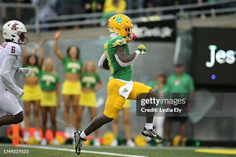 Bucky Irving of the Oregon Ducks runs in for a touchdown against the ...