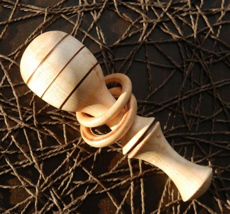 Wood turned baby rattle in birdseye maple with two captured rings | Baby rattle, Wood turning ...