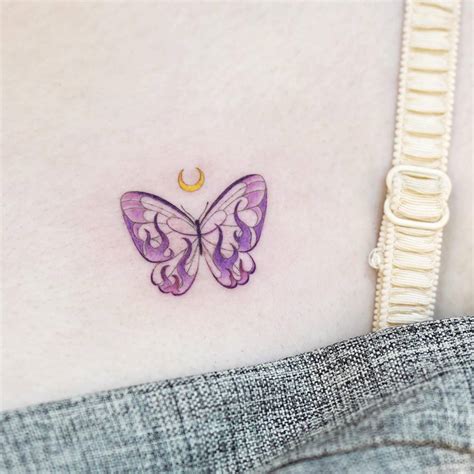 Pink butterfly tattoo placed on the chest.