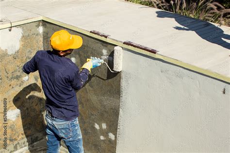 Applying epoxy paint on a surface of a pool Stock Photo | Adobe Stock