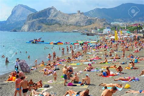 SUDAK, UKRAINE - SEPT 08, 2015: People at a sea beach in Sudak... | Tourist, Travel, Beach