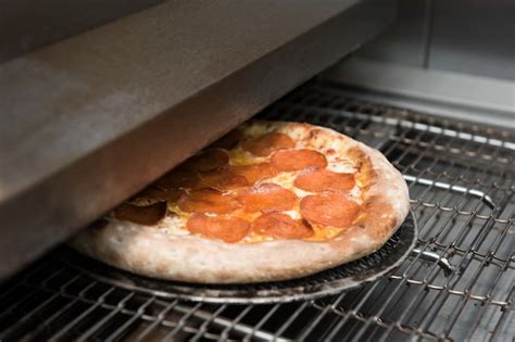 Premium Photo | Preparing pizza in oven