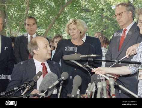 James Brady, seated and his wife Sarah Brady, right, greet reporters ...