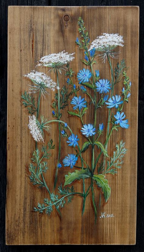 a painting of blue and white flowers on a wooden board