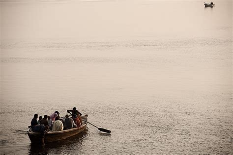 Guided Ganges - Two evening guided boat tours are traveling toward each other on the Ganges, one ...