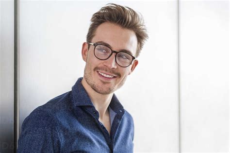 Portrait of smiling young man wearing glasses stock photo