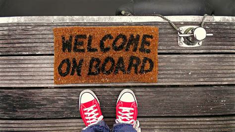 Person Standing Near Brown Welcome on Board-printed Floor Map · Free Stock Photo