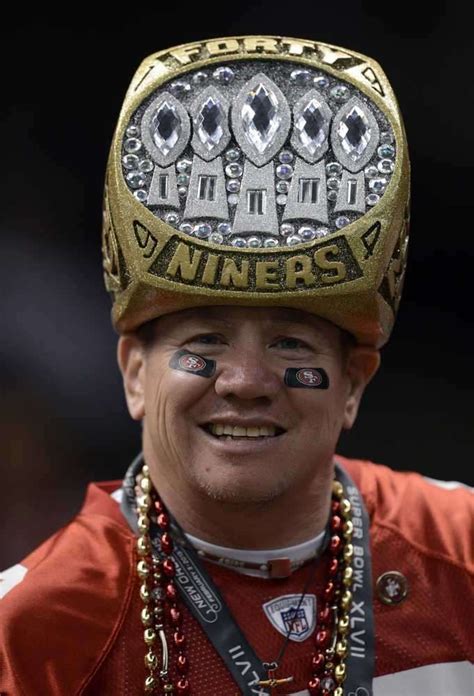 a close up of a man wearing a football helmet with his face painted on it