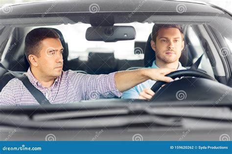 Car Driving School Instructor Teaching Male Driver Stock Photo - Image of student, person: 159620262