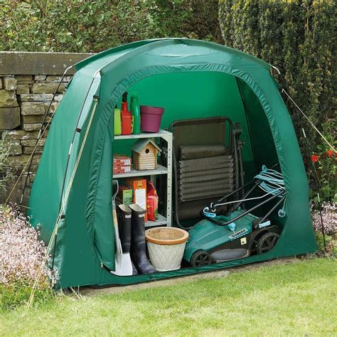 a green tent with gardening equipment in it