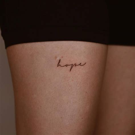 Tattoo of the word "hope" done on the thigh.