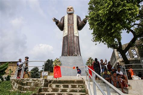 Devotees visit the 50-ft. image of Padre Pio at Padre Pio Mountain of Healing in Sa Jose del ...