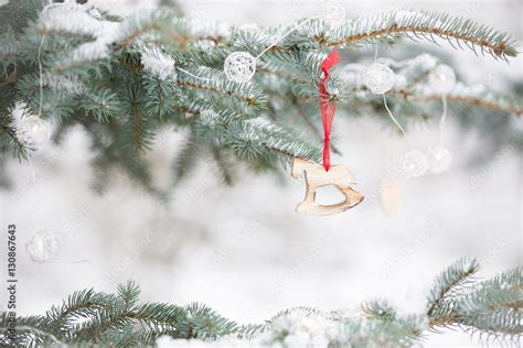 Nice decorations on a Christmas tree with snow outdoors. Celebration ...