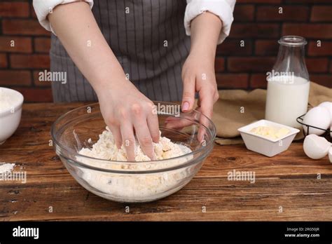 Preparing tasty baklava. Woman making dough at wooden table, closeup ...