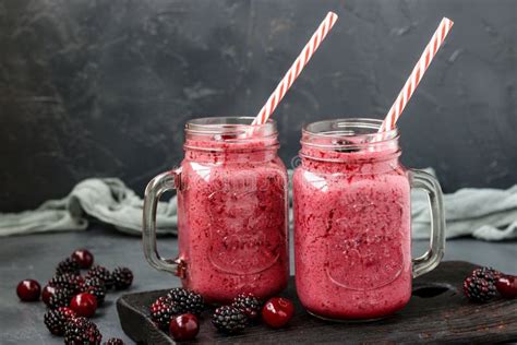 Smoothies with Blackberries and Cherries in Glass on a Dark Background ...