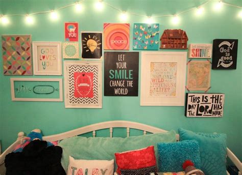 a bed with lots of pillows and pictures on the wall