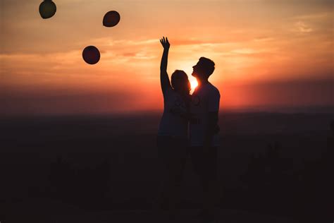 Download Silhouette Couple Releasing Balloons Wallpaper | Wallpapers.com
