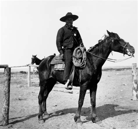 An African-American cowboy sits saddled on his horse in Pocatello ...