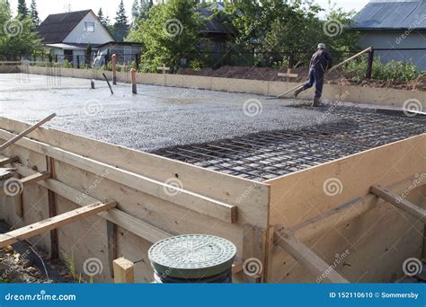 Worker Leveling Fresh Concrete Slab with a Special Working Tool ...