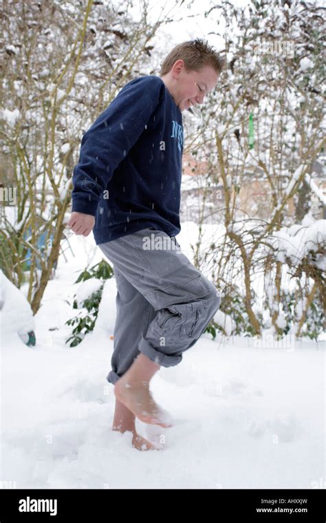 young boy walking barefoot in snow Stock Photo - Alamy