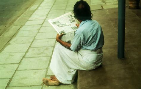 An Old Man Reading a Newspaper on the Street Editorial Image - Image of lankian, yellow: 272004000