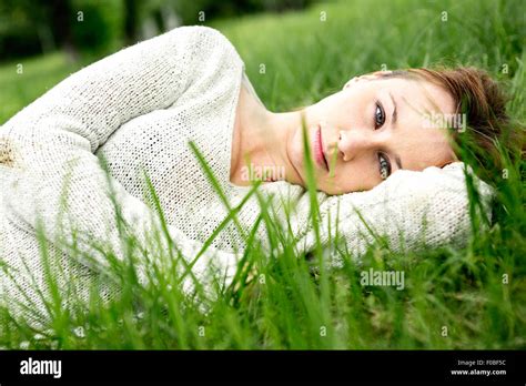 beautiful girl lying down of grass Stock Photo - Alamy