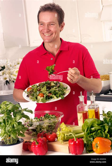 MAN EATING MIXED SALAD Stock Photo - Alamy