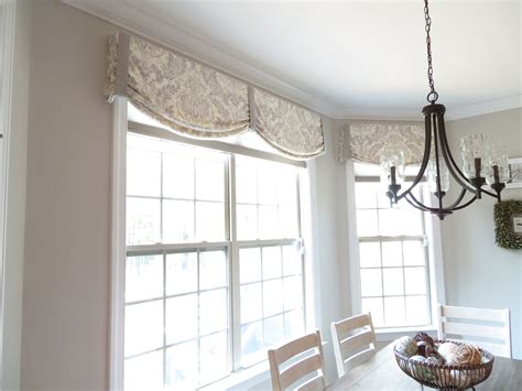 Soft linen relaxed roman shade with contrast bands finish this kitchen perfectly. The valance is ...