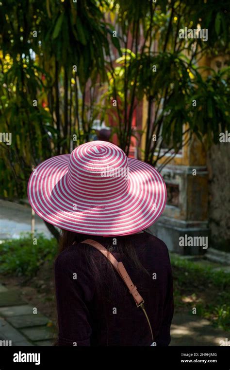 Pink and white hat approaches the Chuong Duc Gate, Imperial City, Hue, Viet Nam Stock Photo - Alamy